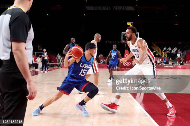 Devin Booker of Team United States tries to get past Rudy Gobert of Team France during the Men's Basketball Preliminary Round Group A - Match 4...