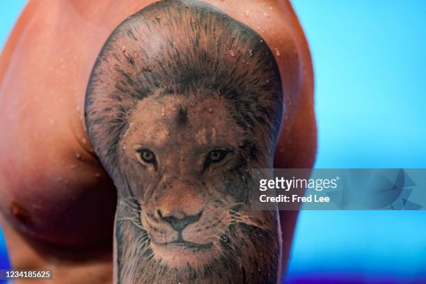 Close-up of Adam Peaty of Great Britain's Lion tattoo after he wins his 100m breaststroke semi-final on day two of the Tokyo 2020 Olympic Games at...
