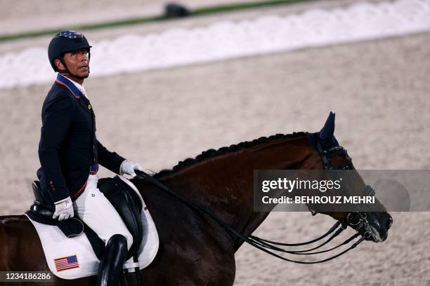 Steffen Peters riding Suppenkasper looks at the scoreboard after competing in the dressage grand prix competition during the Tokyo 2020 Olympic Games...
