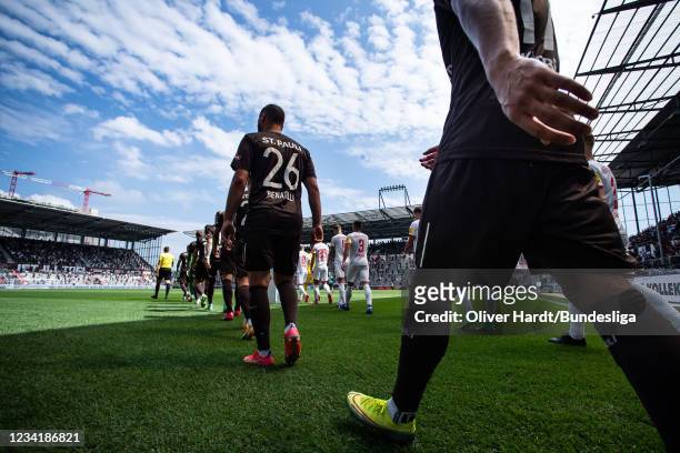 Players enters the pitch prior to the Second Bundesliga match between FC St. Pauli and Holstein Kiel at Millerntor Stadium on July 25, 2021 in...