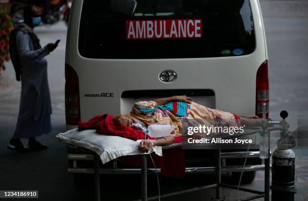 Patient waits to be transferred to a different hospital because the ICU at the hospital she was admitted to was full, on July 25, 2021 in Dhaka,...