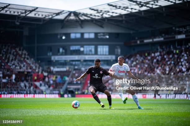 Xxx of FC St. Pauli competes for the ball with xxx of Holstein Kiel during the Second Bundesliga match between FC St. Pauli and Holstein Kiel at...