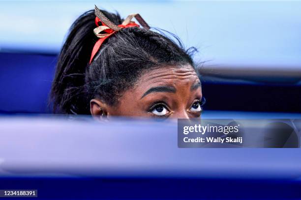 July 24, 2021: USA's Simone Biles peaks over the wall to see her score after competing on the beam in the women's team qualifying at the 2020 Tokyo...