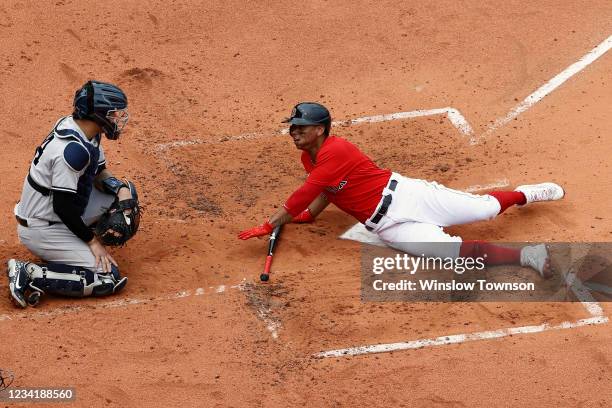 Rafael Devers of the Boston Red Sox looks back at Gary Sanchez of the New York Yankees after he was almost hit by a pitch during the second inning at...