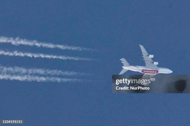 Emirates Airbus A380 aircraft as seen flying in the blue summer sky over Greece in Europe the route EK142 from Madrid MAD, Spain to Dubai DXB, UAE....