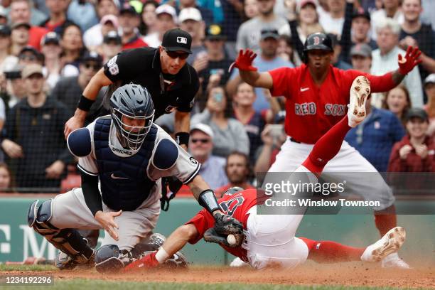 Enrique Hernandez of the Boston Red Sox slides home safely ahead of the tag by catcher Gary Sanchez of the New York Yankees to score the go ahead run...