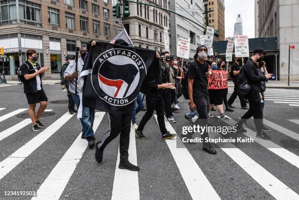 Left wing protesters, some affiliated with Antifa, hold a counter protest against right wing protesters participating in a political rally on July...