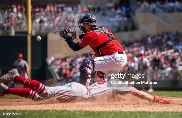 Brandon Marsh of the Los Angeles Angels slides across home plate to score a run in the ninth inning of the game against the Minnesota Twins at Target...