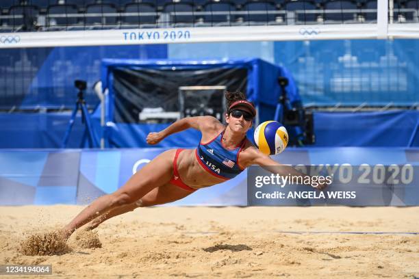 S Sarah Sponcil reaches for the ball in their women's preliminary beach volleyball pool D match between the USA and Latvia during the Tokyo 2020...