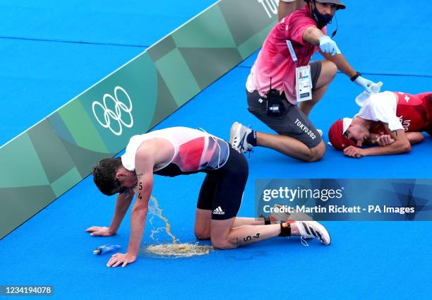 Great Britain's Jonny Brownlee vomits after finishing fifth in the Men's Triathlon at the Odaiba Marine Park on the third day of the Tokyo 2020...