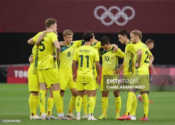 Australia's starting players gather on the pitch prior to their Tokyo 2020 Olympic Games men's group C first round football match between Australia...