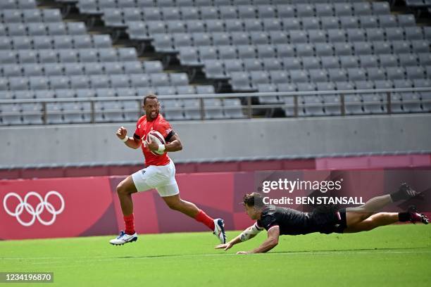 Britain's Dan Norton runs for the try in the men's pool B rugby sevens match between Britain and Canada during the Tokyo 2020 Olympic Games at the...