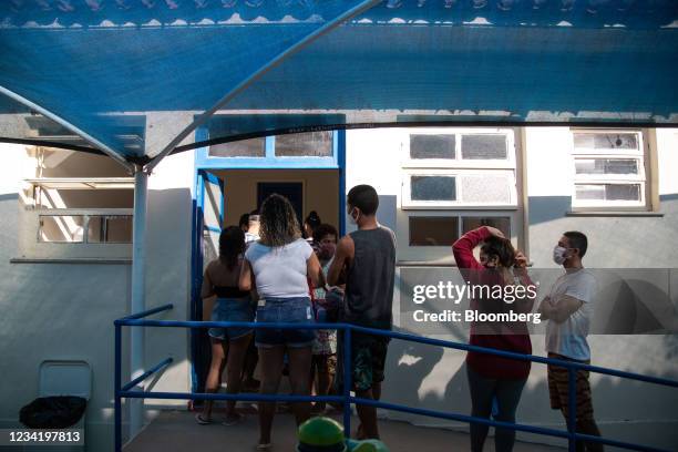 People line up to recieve the Pfizer-BioNTech Covid-19 vaccine during Fiocruz's PaqueTa Vacinada mass vaccination event at the Manoel Arthur...