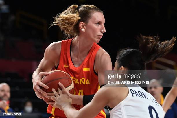 South Korea's Park Jihyun fights for the ball with Spain's Laura Gil in the women's preliminary round group A basketball match between South Korea...