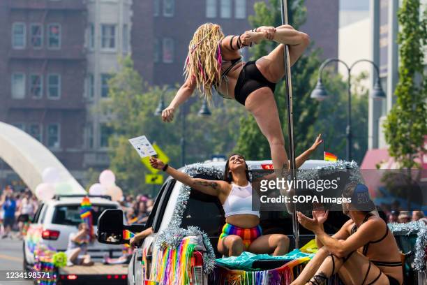 Dancers perform in the back of a pick up, during the pride parade through the heart of the city, celebrated by thousands who came out for the event.