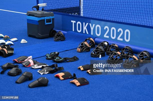 Protection used by players is seen behind a goal during the men's pool B match of the Tokyo 2020 Olympic Games field hockey competition between...