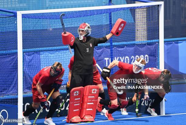 Canada's goalkeeper Antoni Pawel Kindler and teammates defend their goal during their a penalty corner in favour of Britain during their men's pool B...