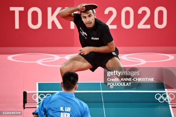 Egypt's Omar Assar competes against Ukraine's Lei Kou during their men's singles round 2 table tennis match at the Tokyo Metropolitan Gymnasium...