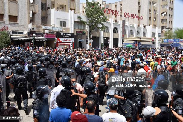 Tunisian security forces face off with protesters during a rally against Ennahdha party and the government at the Parliament. Supreme Council for...