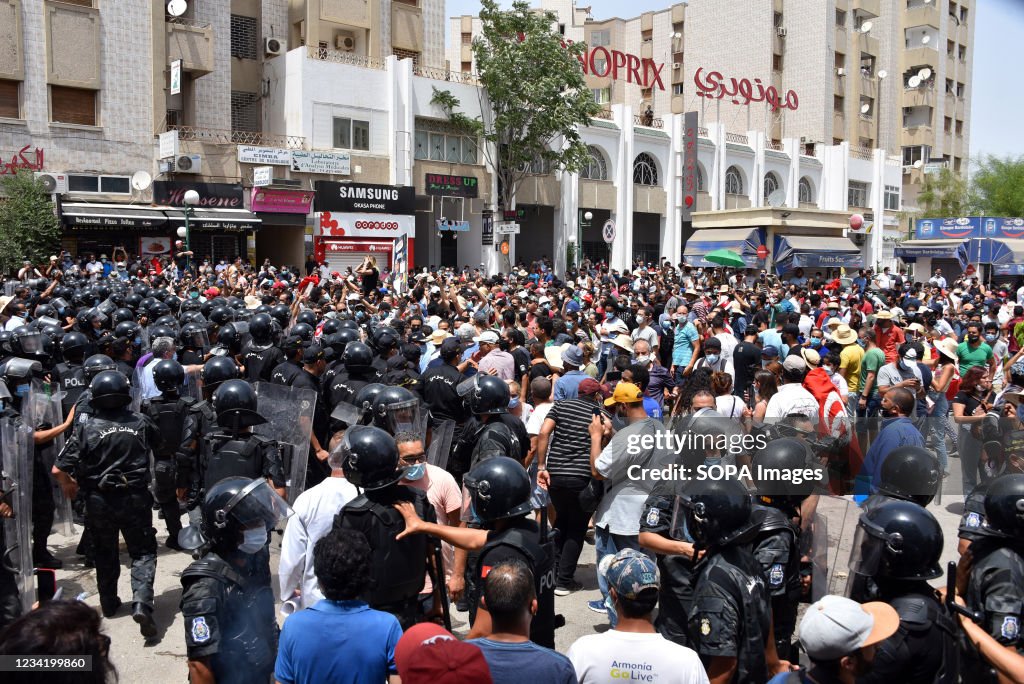 Tunisian security forces face off with protesters during a...