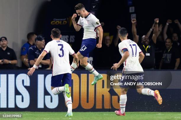 S forward Matthew Hoppe celebrates after scoring as defender Sam Vines and forward Sebastian Lletget run towards him during the Concacaf Gold Cup...