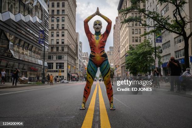 Participant poses for photos on a road during the annual NYC Bodypainting Day near Union Square in New York on July 25, 2021. - The annual...