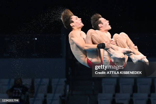 Canada's Vincent Riendeau and Canada's Nathan Zsombor-Murray compete in the men's synchronised 10m platform diving final event during the Tokyo 2020...