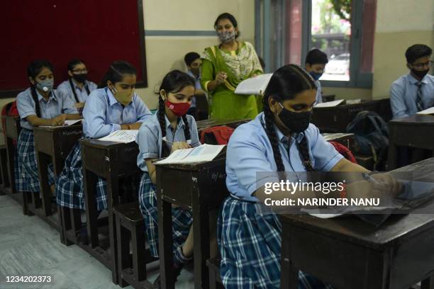 School children attent their class inside a school after authorities relaxed the lockdown norms and reopened educational institutions in Amritsar on...