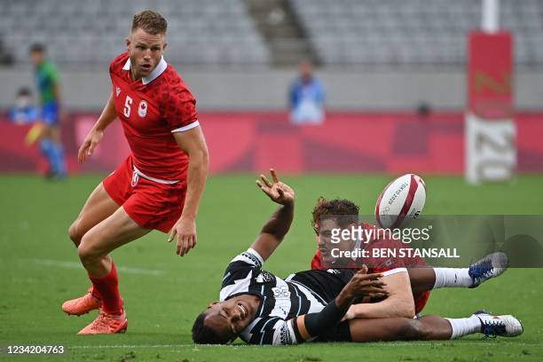 Fiji's Sireli Maqala is tackled by Canada's Phil Berna in the men's pool B rugby sevens match between Fiji and Canada during the Tokyo 2020 Olympic...