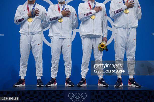 S gold medallists Caeleb Dressel, Blake Pieroni, Bowen Becker and Zach Apple pose with their medals on the podium after the final final of the men's...