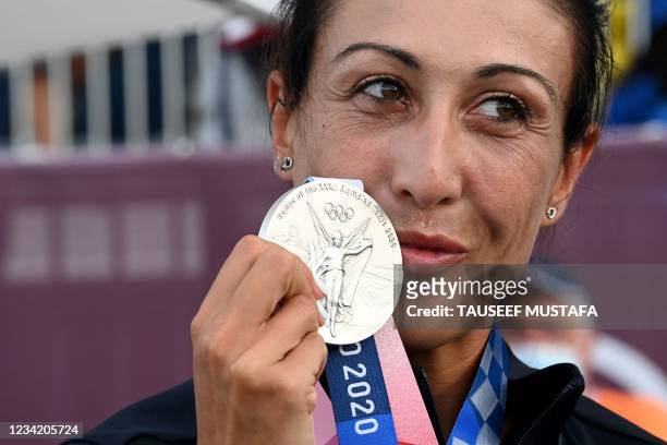 Italy's Diana Bacosi poses on the podium with her silver medal after the womens skeet final during the Tokyo 2020 Olympic Games at the Asaka Shooting...