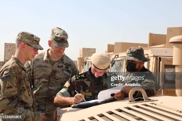 Soldiers are seen after the US-led coalition against Daesh provided military vehicle assistance to the Peshmerga forces of Iraq's Kurdish Regional...