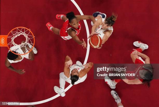 Canada's Nirra Fields fights for the ball with Serbia's Tina Krajisnik in the women's preliminary round group A basketball match between Serbia and...