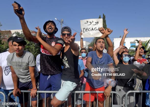 Supporters of Tunisia's President Kais Saied chant slogans denouncing the country's main Islamist Ennahda party in front of the Parliament which was...