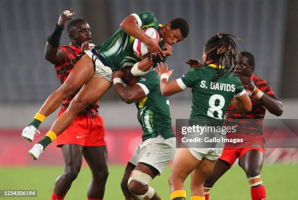 Kurt-Lee Arendse of South Africa is lifted high into the air by Siviwe Soyizwapi, captain of South Africa, during the Rugby Sevens match between...