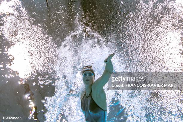 An underwater view shows Italy's Federica Pellegrini competing in a heat for the women's 200m freestyle swimming event during the Tokyo 2020 Olympic...
