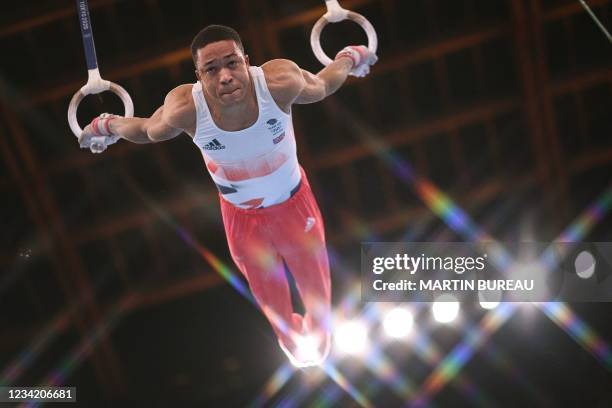 Britain's Joe Fraser competes in the rings event of the artistic gymnastics men's team final during the Tokyo 2020 Olympic Games at the Ariake...