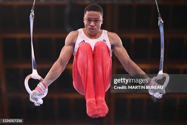 Britain's Joe Fraser competes in the rings event of the artistic gymnastics men's team final during the Tokyo 2020 Olympic Games at the Ariake...