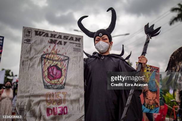 Filipino protester wearing a costume attempts to march towards Philippine Congress to call for an end to Duterte's presidency on July 26, 2021 in...