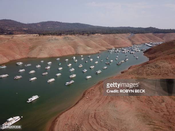 In this aerial photo houseboats sit in low water on Lake Oroville as California's drought emergency worsens, July 25, 2021 in Oroville, California. -...