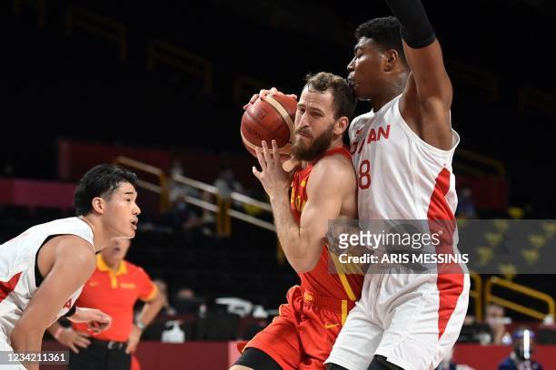 Spain's Sergio Rodriguez fights for the ball with Japan's Rui Hachimura in the men's preliminary round group C basketball match between Japan and...