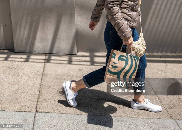 Pedestrian carries a Starbucks branded shopping bag in San Francisco, California, U.S., on Thursday, July 22, 2021. Starbucks Corp. Is expected to...