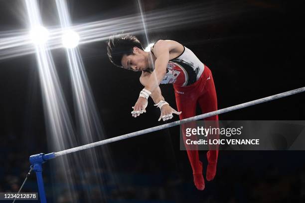 Japan's Kazuma Kaya competes in the horizontal bars event of the artistic gymnastics men's team final during the Tokyo 2020 Olympic Games at the...