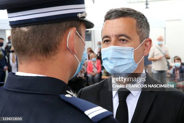 French Interior Minister Gerald Darmanin faces a police officer during a visit to a police station in Saint-Dizier, eastern France, on July 26, 2021....