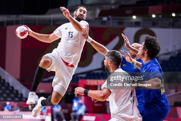 Nikola Karabatic of France, Luka Karabatic of France, Thiagus Petrus of Brazil battle for the ball on day three in the Men's First Round Group A...