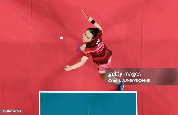 In this overview image Japan's Mima Ito hits a shot against China's Xu Xin and Liu Shiwen in their mixed doubles table tennis final match at the...