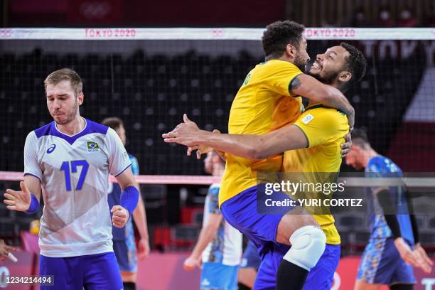 Brazil's players celebrate their victory in the men's preliminary round pool B volleyball match between Brazil and Argentina during the Tokyo 2020...