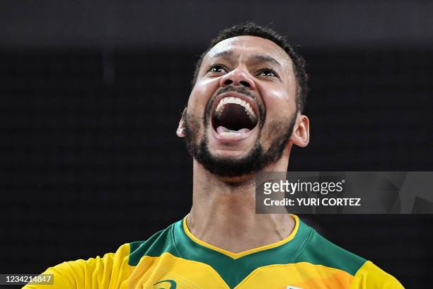 Brazil's Alan Souza celebrates victory in the men's preliminary round pool B volleyball match between Brazil and Argentina during the Tokyo 2020...
