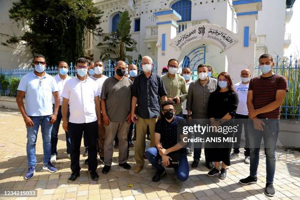 Al Jazeera bureau chief Lotfi Hajji and his team pose for a picture outside the National Syndicat headquarters in the Tunisian capital Tunis on July...