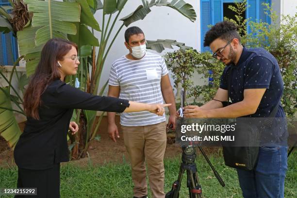 Al Jazeera journalists go live from the National Syndicat headquarters in the Tunisian capital Tunis on July 26, 2021. - Tunisian police closed the...